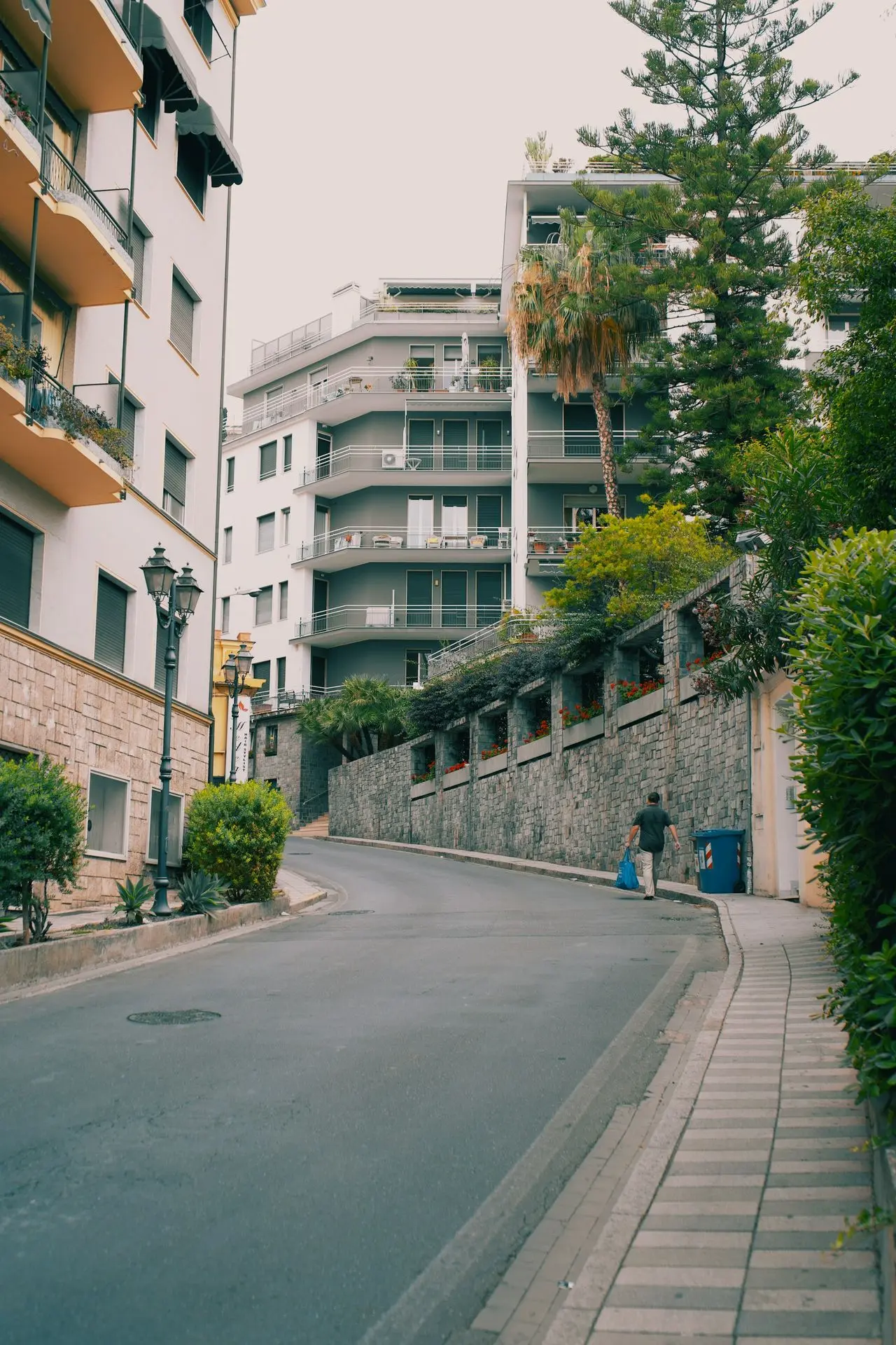 An empty street in a city with tall buildings